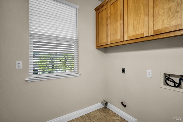 laundry area with hookup for a washing machine, tile patterned floors, hookup for an electric dryer, hookup for a gas dryer, and baseboards
