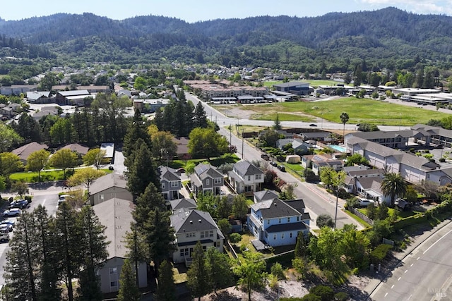 bird's eye view featuring a mountain view, a forest view, and a residential view