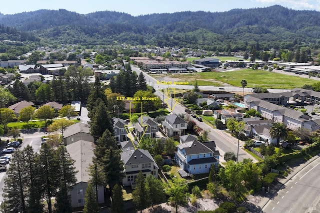 bird's eye view with a wooded view, a mountain view, and a residential view