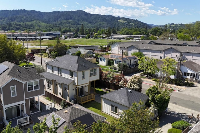 aerial view with a mountain view, a residential view, and a view of trees