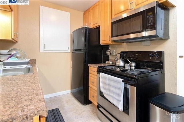 14375 Doolittle Dr, San Leandro, CA 94577 - kitchen with stainless steel appliances, a sink, light countertops, and baseboards