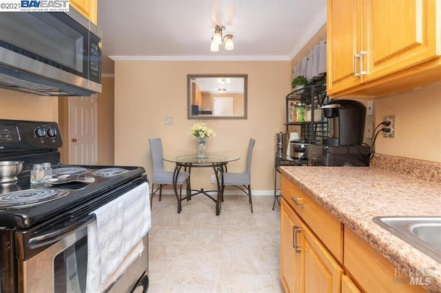14375 Doolittle Dr, San Leandro, CA 94577 - kitchen with stainless steel appliances, crown molding, baseboards, and light floors