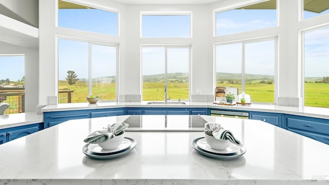 sunroom / solarium with plenty of natural light and a sink