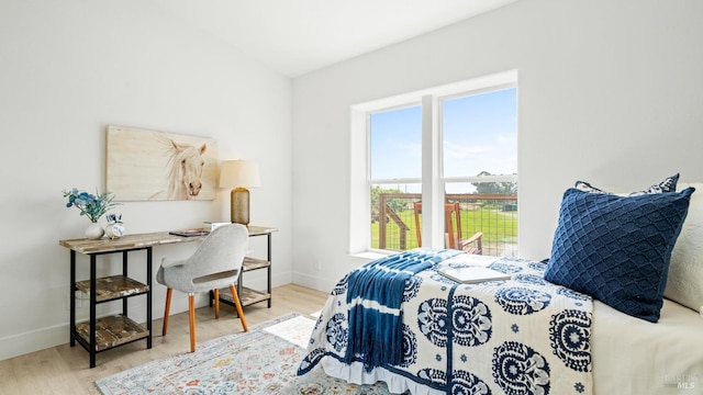 bedroom with baseboards and wood finished floors