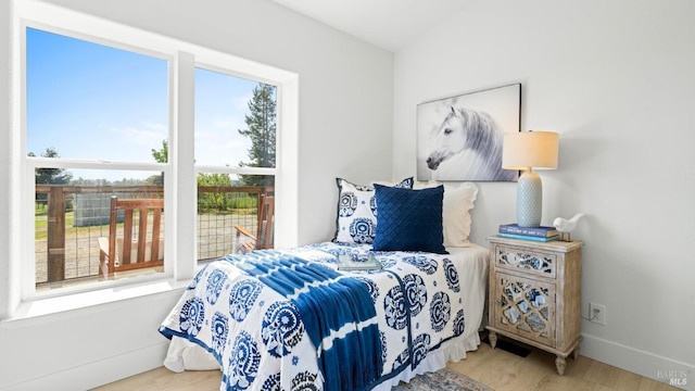 bedroom featuring wood finished floors and baseboards