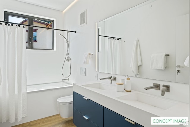 bathroom with shower / bath combo, vanity, toilet, visible vents, and wood finished floors