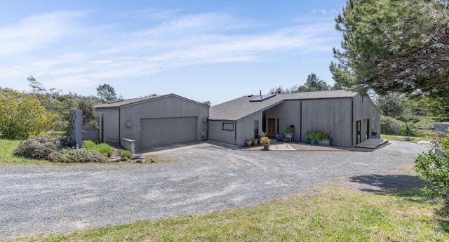 contemporary house featuring a detached garage