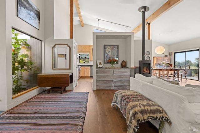 bedroom featuring access to exterior, beam ceiling, light wood finished floors, rail lighting, and high vaulted ceiling
