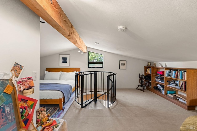 carpeted bedroom with a textured ceiling and vaulted ceiling