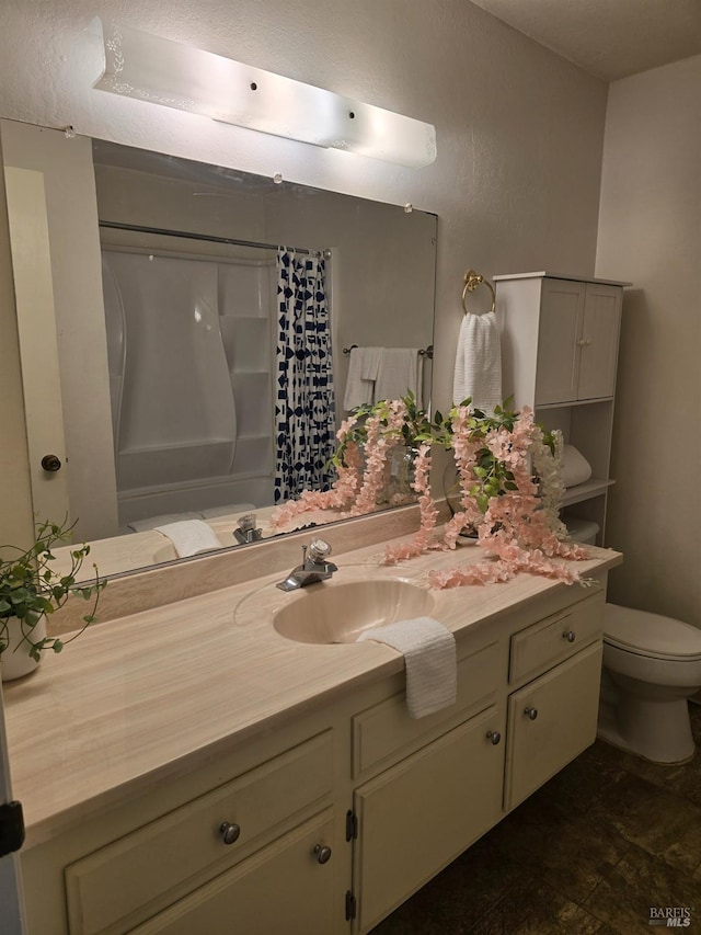 bathroom with toilet, vanity, and a shower with shower curtain