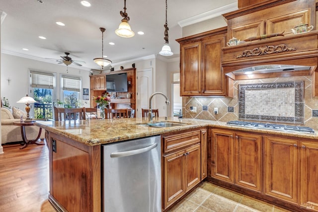 kitchen with a sink, ceiling fan, stainless steel appliances, recessed lighting, and ornamental molding