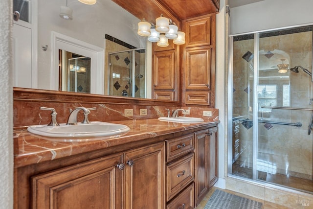 full bathroom with a stall shower, double vanity, a sink, and decorative backsplash