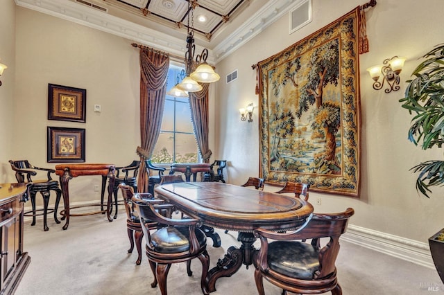 dining space with baseboards, visible vents, a high ceiling, and crown molding