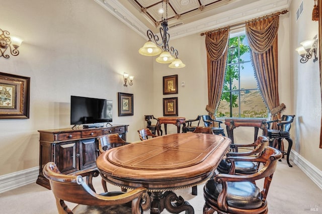 dining area with light colored carpet, visible vents, baseboards, ornamental molding, and a high ceiling