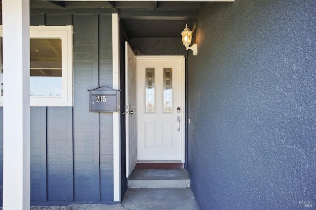 doorway to property with board and batten siding