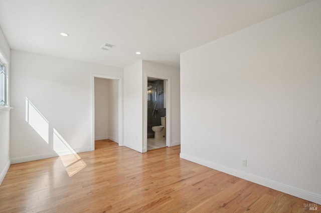 empty room featuring visible vents, light wood-type flooring, recessed lighting, and baseboards
