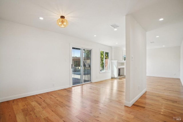 unfurnished living room with visible vents, light wood-type flooring, recessed lighting, and baseboards