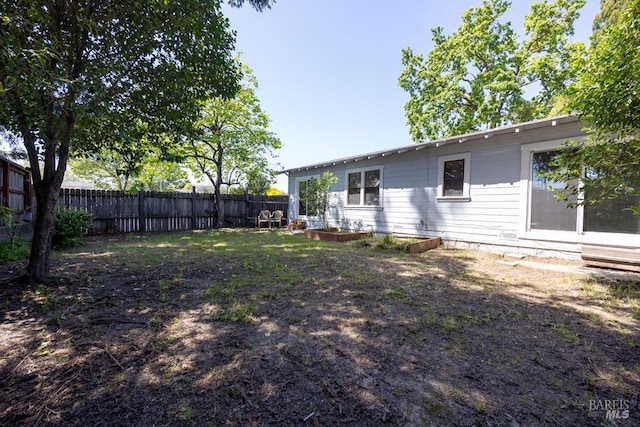 view of yard with a fenced backyard