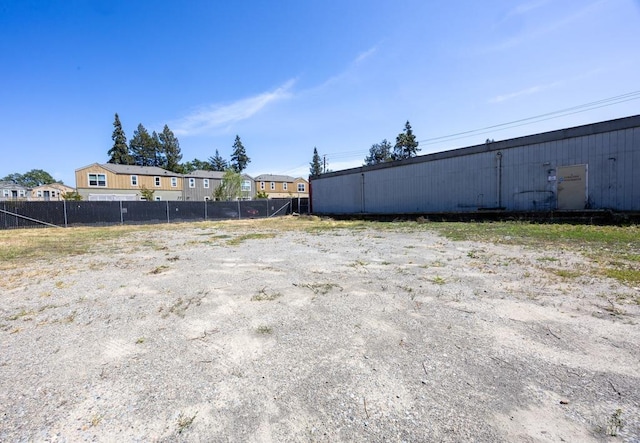 view of yard featuring a residential view and fence