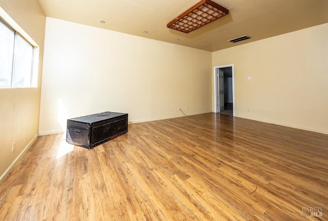 empty room with visible vents and wood finished floors