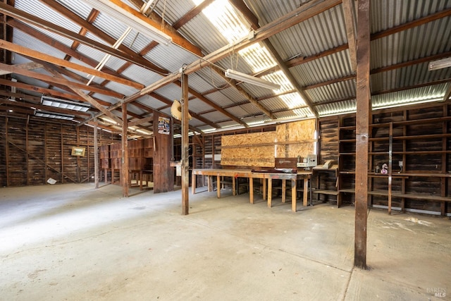 miscellaneous room with concrete floors and a workshop area