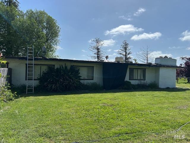 view of front of home with a front lawn and stucco siding