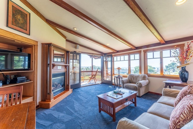 living room featuring a glass covered fireplace, a healthy amount of sunlight, lofted ceiling with beams, and carpet floors