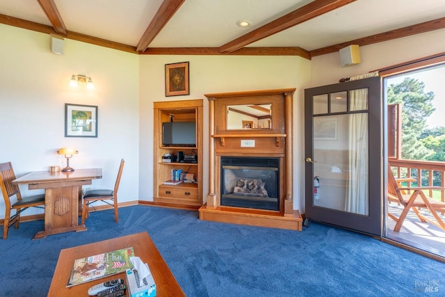 living room featuring beam ceiling, a glass covered fireplace, baseboards, and carpet floors