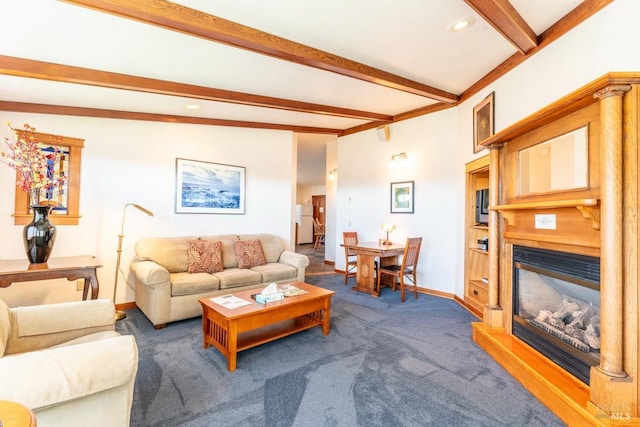 living room featuring beam ceiling, a glass covered fireplace, baseboards, and carpet floors