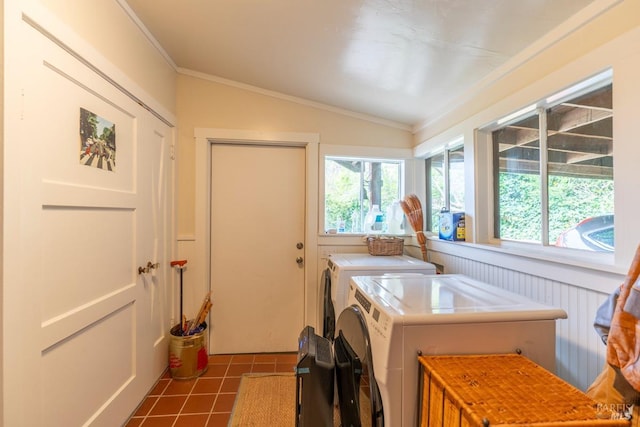 laundry area featuring dark tile patterned floors, washing machine and clothes dryer, laundry area, and crown molding
