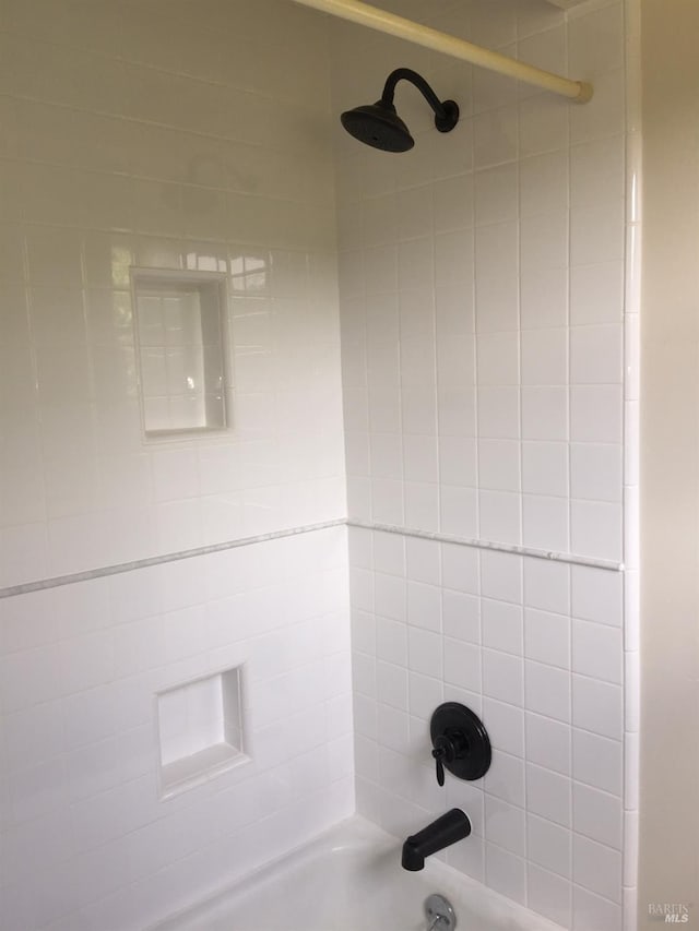room details featuring shower / tub combination