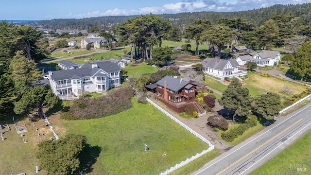 birds eye view of property featuring a wooded view and a residential view