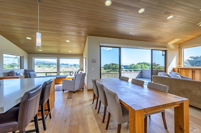 dining room with recessed lighting, a wealth of natural light, and lofted ceiling