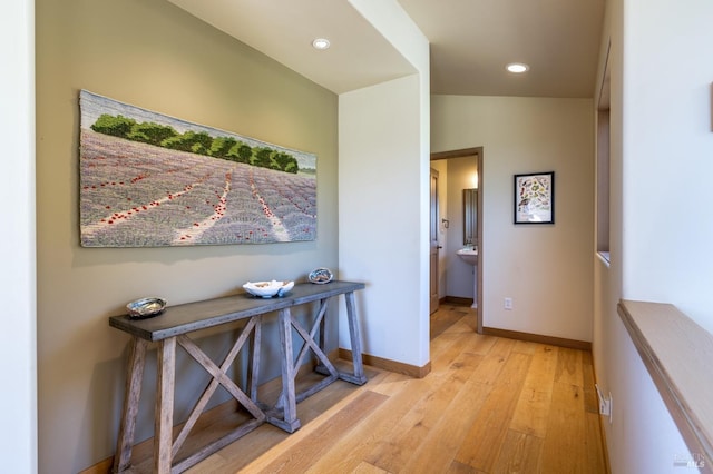 corridor with recessed lighting, wood finished floors, and baseboards