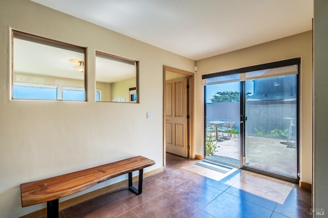 entryway with baseboards and tile patterned floors