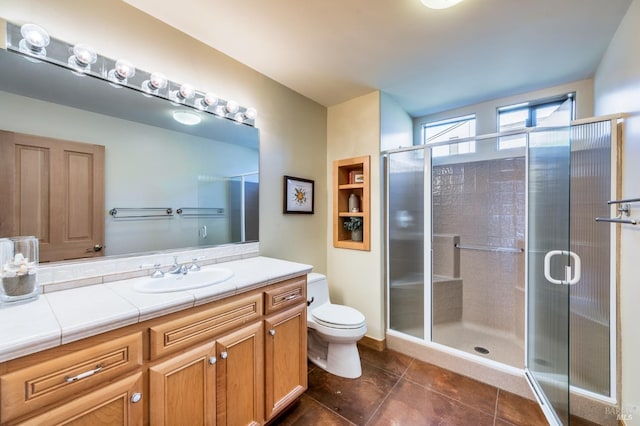 full bath featuring toilet, a stall shower, tile patterned flooring, and vanity