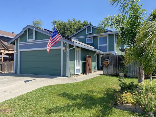 view of front of property featuring concrete driveway, a front yard, a garage, and fence
