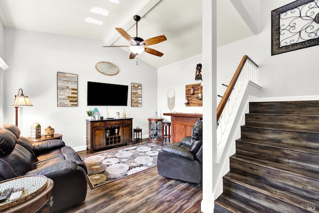 living area featuring wood finished floors, stairway, a ceiling fan, baseboards, and vaulted ceiling with beams