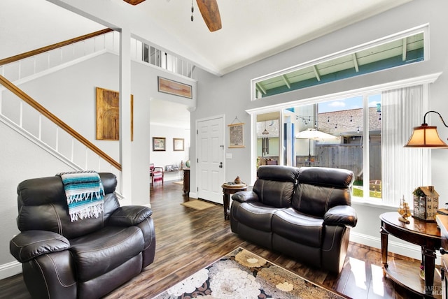 living area featuring a ceiling fan, stairway, and wood finished floors