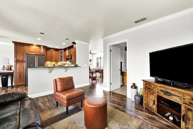 living room with ornamental molding, visible vents, recessed lighting, dark wood finished floors, and baseboards