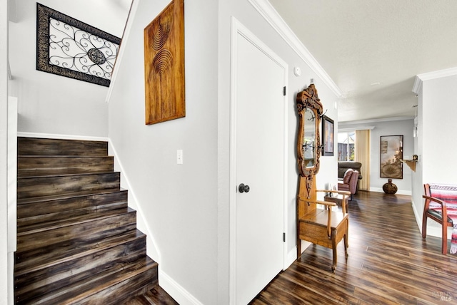 stairs with baseboards, ornamental molding, and wood finished floors