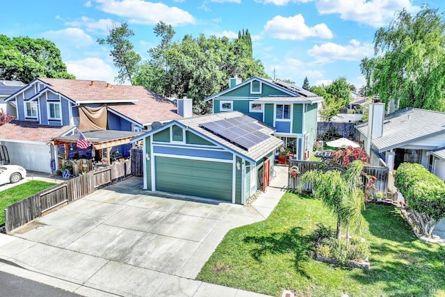 view of front of home featuring fence, concrete driveway, a garage, solar panels, and a front lawn