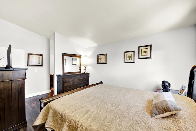 bedroom featuring baseboards and dark wood finished floors