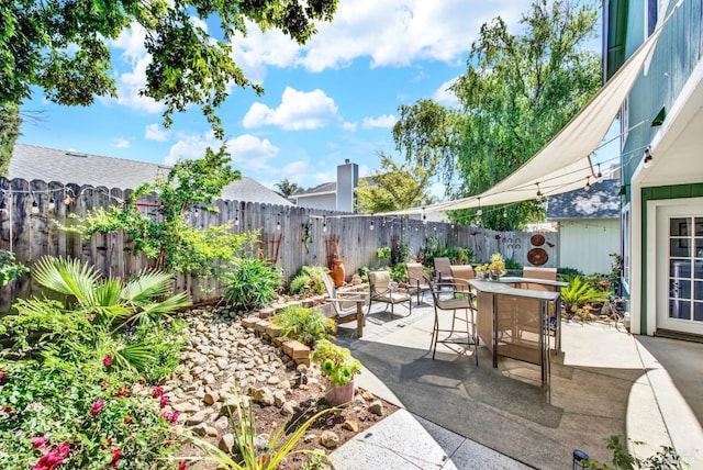 view of patio with a fenced backyard and outdoor dining area