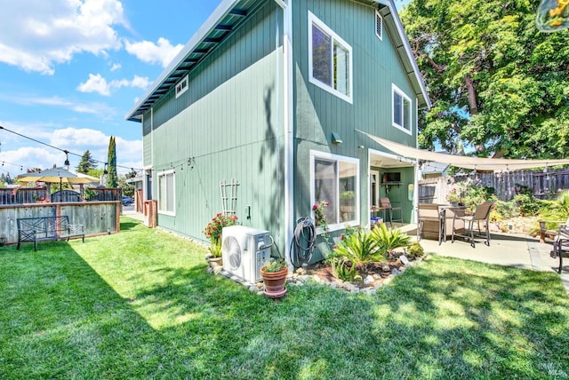 back of property featuring fence, a patio, ac unit, and a lawn