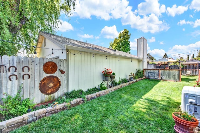 exterior space with a yard, a chimney, and fence