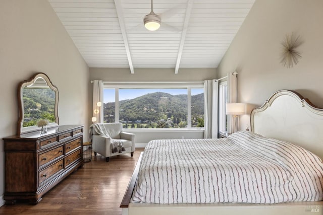 bedroom with lofted ceiling with beams, a mountain view, and dark wood-type flooring