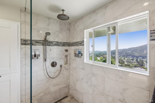 full bath with a tile shower