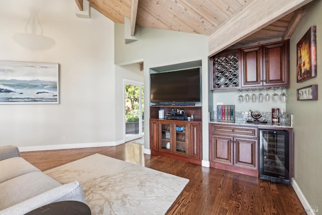 living area with wood ceiling, beverage cooler, lofted ceiling with beams, and a bar