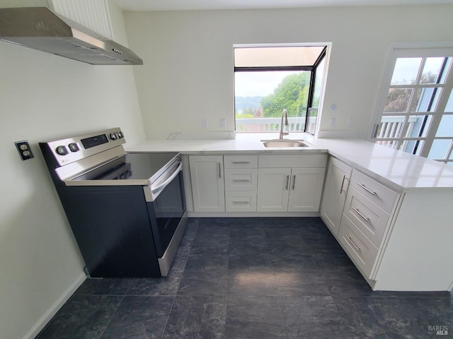 117 Sunset Cir Unit 36, Benicia, CA 94510 - kitchen featuring stainless steel range with electric stovetop, wall chimney exhaust hood, a sink, and plenty of natural light